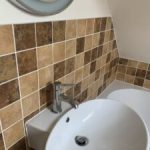 Bathroom basin with tiled splashback