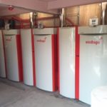 Row of commercial boilers in a plant room