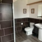 Tiled bathroom with walk-in shower enclosure