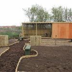 Hideaway community garden after renovation with new paths and wooden shelter